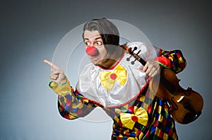Funny violin clown player in musical concept