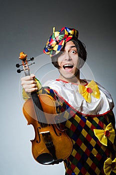 Funny violin clown player in musical concept