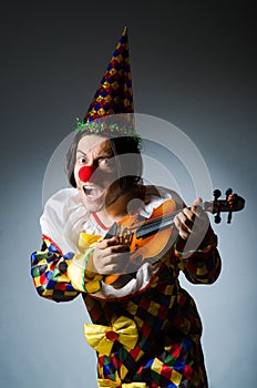 Funny violin clown player in musical concept