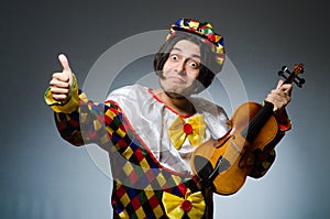 The funny violin clown player in musical concept