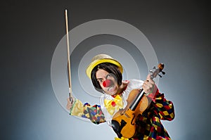 The funny violin clown player in musical concept