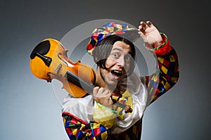 The funny violin clown player in musical concept