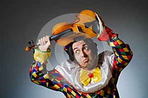 The funny violin clown player in musical concept