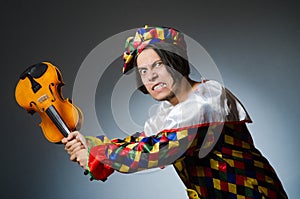 The funny violin clown player in musical concept