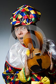 The funny violin clown player in musical concept