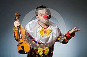 The funny violin clown player in musical concept