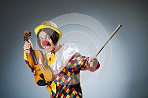 The funny violin clown player in musical concept