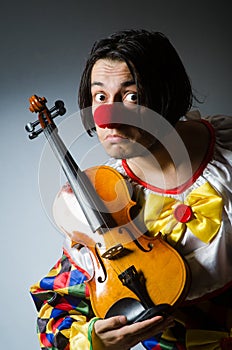 The funny violin clown player in musical concept