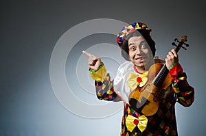 The funny violin clown player in musical concept