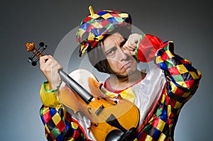 The funny violin clown player in musical concept