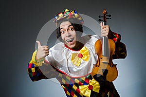 Funny violin clown player in musical concept