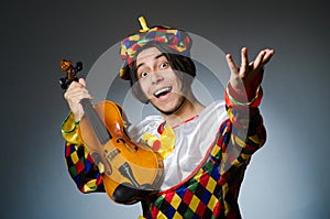 Funny violin clown player in musical concept