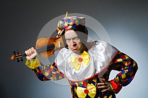 Funny violin clown player in musical concept