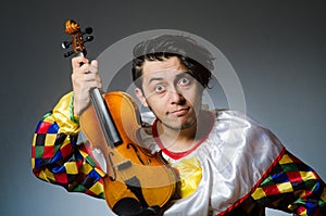 The funny violin clown player in musical concept