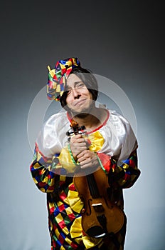 The funny violin clown player in musical concept