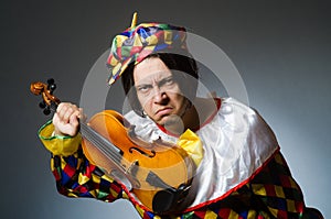 The funny violin clown player in musical concept