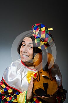 The funny violin clown player in musical concept