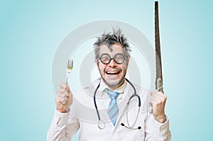 Funny wacky and crazy surgeon doctor holds unusual instruments photo