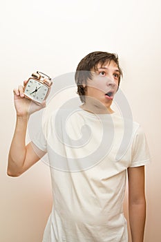 Funny white man hold mechanical alarm clock