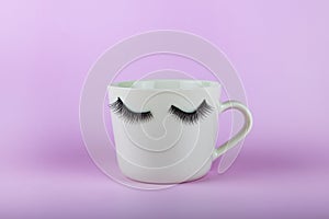 Funny white mug with eyes on a pink background