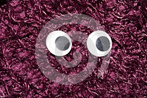 Funny Wiggle Google Eyes on Fabric Background photo