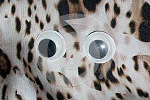 Funny Wiggle Google Eyes on Fabric Background