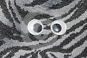 Funny Wiggle Google Eyes on Fabric Background photo