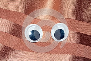 Funny Wiggle Google Eyes on Fabric Background photo