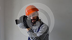 Funny window installer with screwdriver depicts shooting during a break