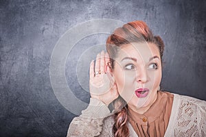 Funny woman eavesdrop on blackboard background