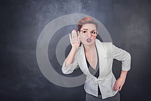 Funny woman eavesdrop on blackboard background