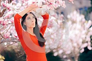 Cute Girl Enjoying Spring Sun Beside Magnolia Tree