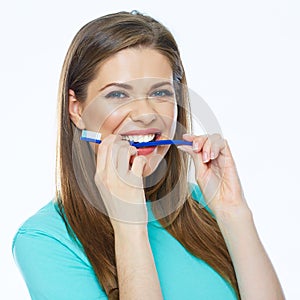 Funny woman face holding toothbrush in mouth.