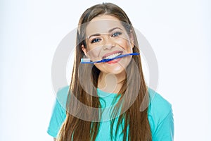 Funny woman face holding toothbrush in mouth.