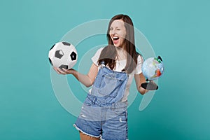 Funny woman football fan cheer up support favorite team with soccer ball, Earth world globe isolated on blue turquoise