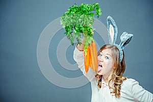 Funny woman with fresh carrot. Picture with space for your text