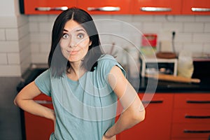 Funny Woman with Hands on Hips Standing in the Kitchen