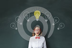 Funny woman having idea over blackboard background