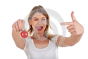 Funny woman holding cherry tomato