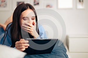 Funny Woman Holding PC Tablet and Laughing