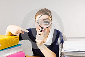 Funny woman office working secretary with magnifier