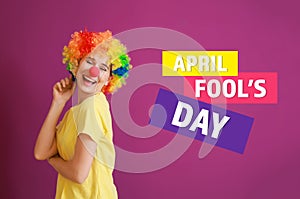 Funny woman with party decor for April Fools\' Day on color background