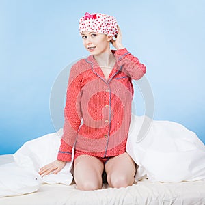 Funny woman wearing pajamas and bathing cap