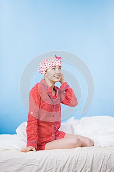 Funny woman wearing pajamas and bathing cap