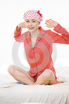 Funny woman wearing pajamas and bathing cap