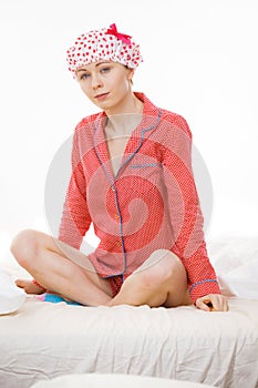 Funny woman wearing pajamas and bathing cap