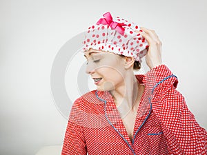 Funny woman wearing pajamas and bathing cap