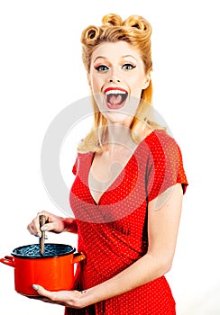 Funny woman winking in the kitchen and cooking,