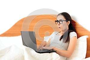 Funny Woman Working From Home On Her Laptop in Bed