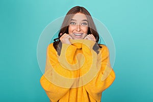 Funny woman in yellow sweater, smiling widely